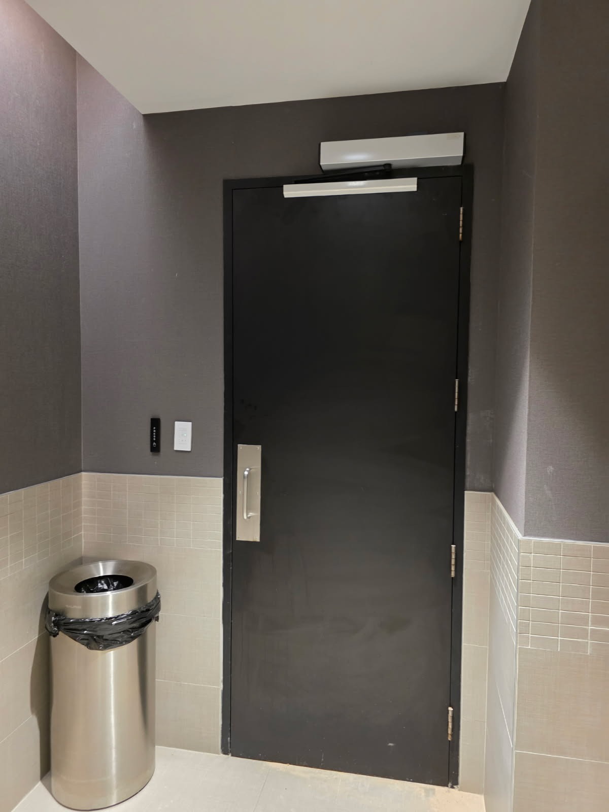 ADA-compliant push-to-exit button and mag lock on interior side of commercial door