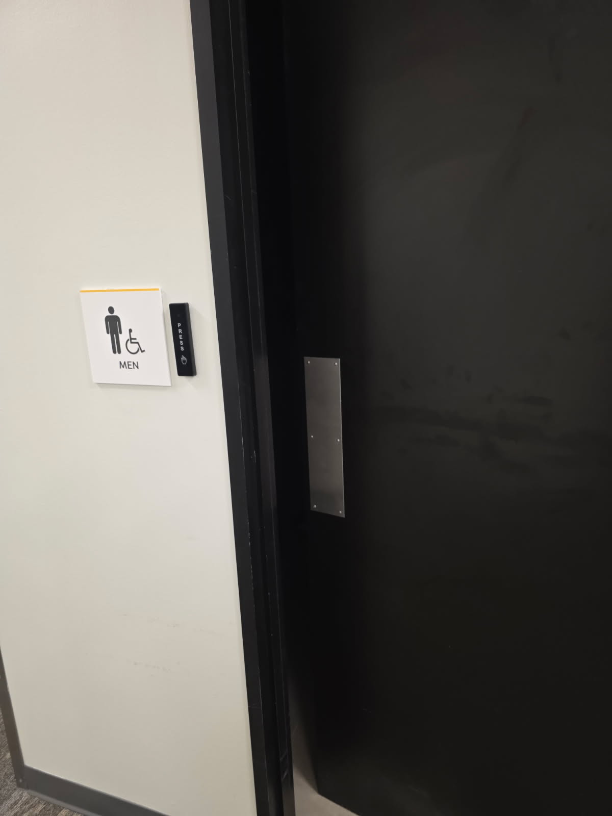 Access control card reader installed next to men's restroom door in Dallas commercial building