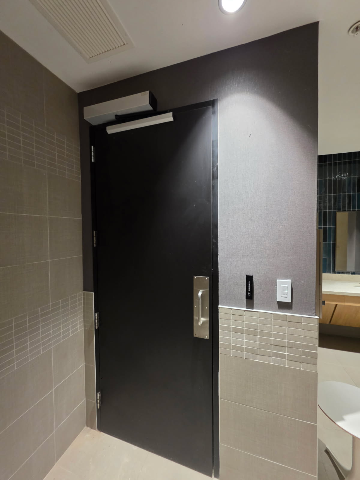 Complete access control installation on commercial restroom door with mag lock, reader, and ADA button