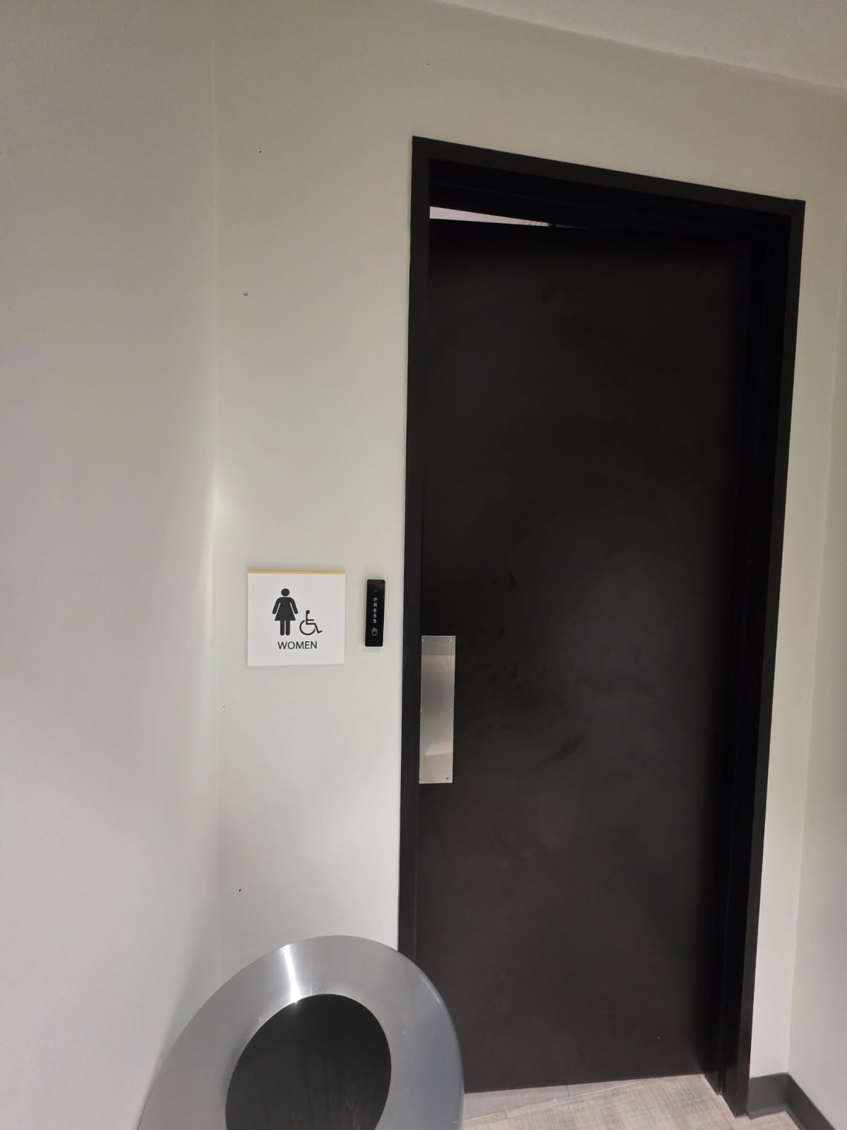 Women's restroom entry with access control card reader and push button in Dallas office building