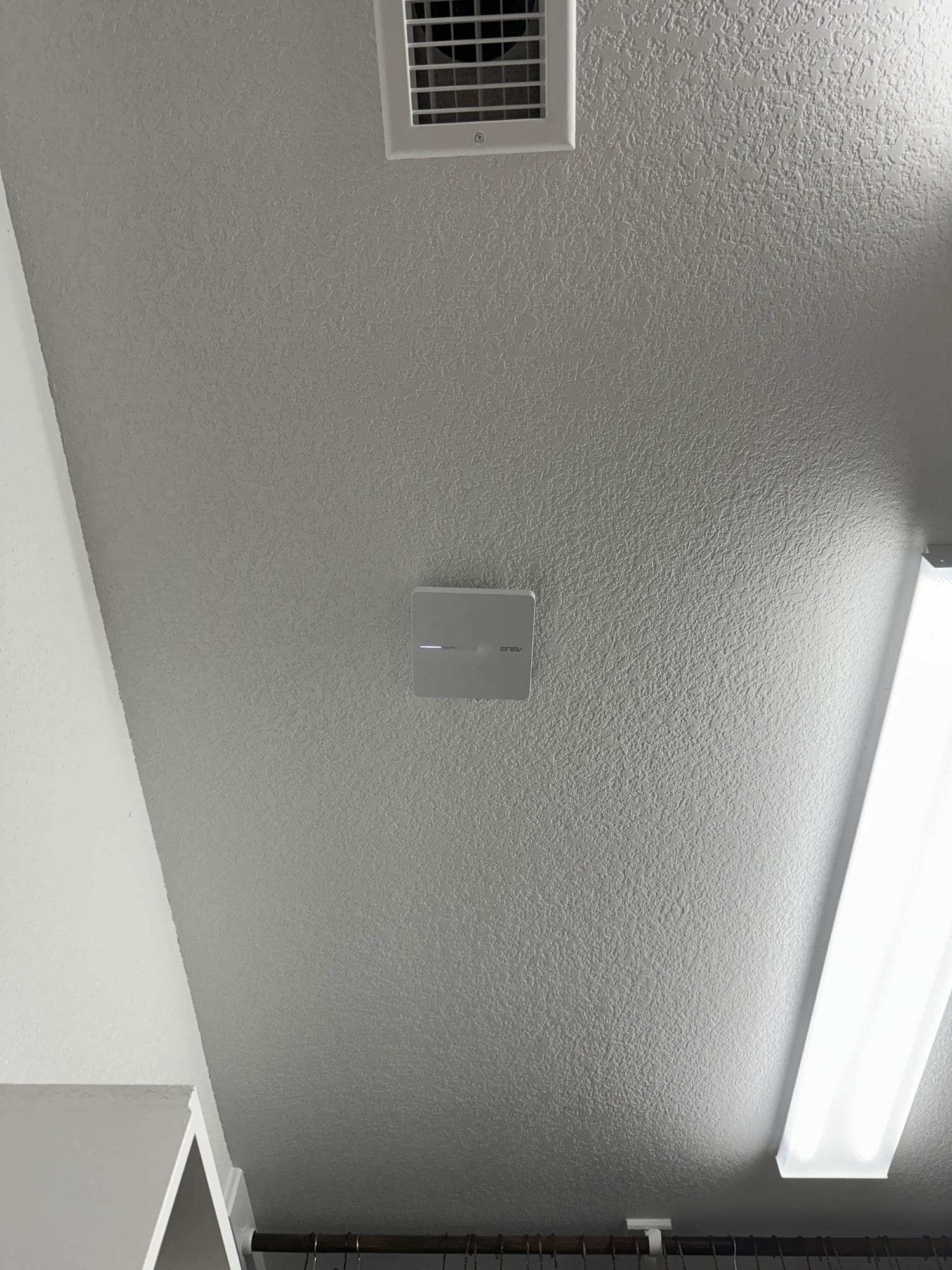 Ceiling-mounted WiFi access point installed in commercial space