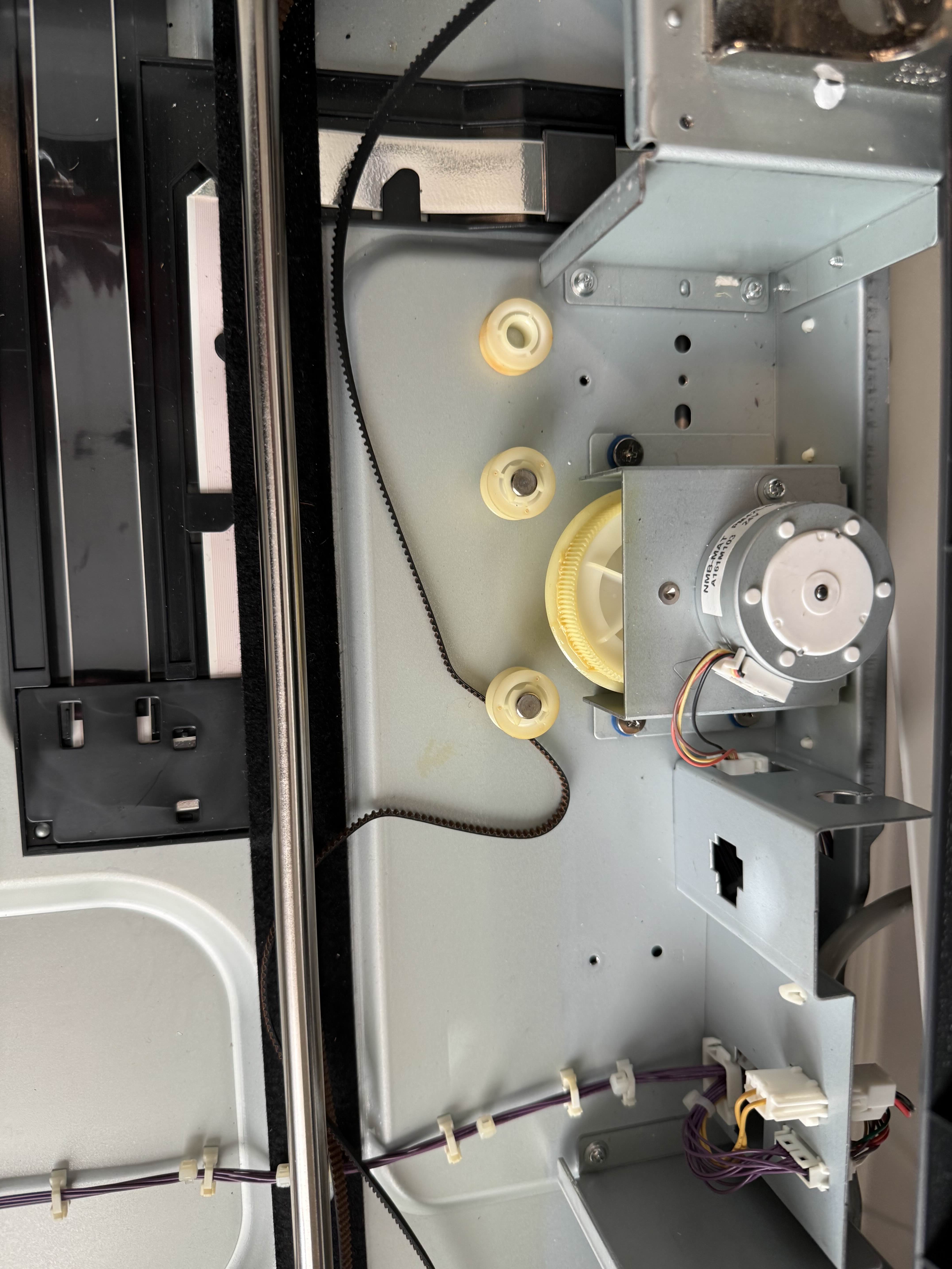 Internal drive mechanism gears and motor inside Konica Minolta bizhub during repair