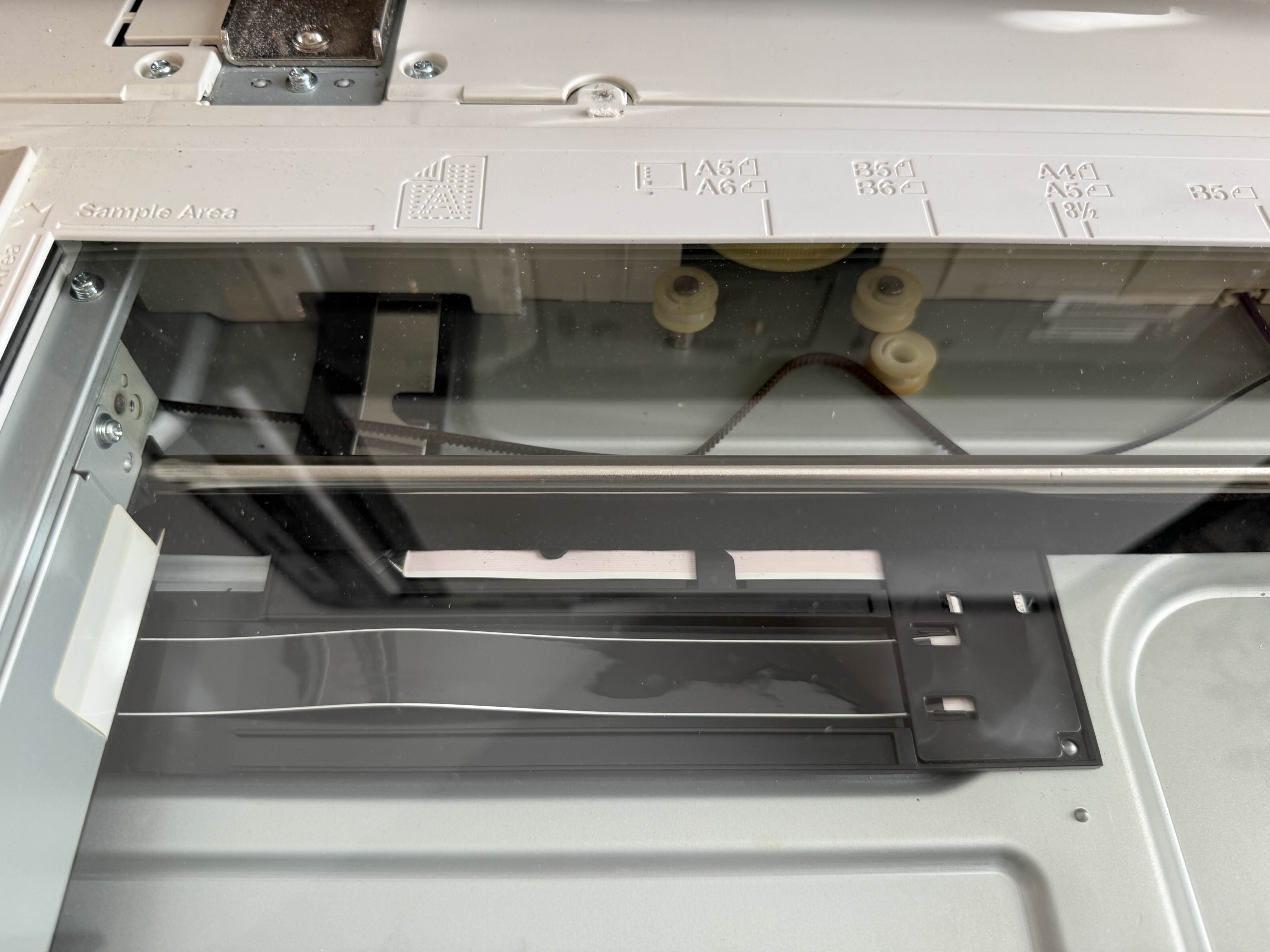 Konica Minolta bizhub scanner glass and ADF rollers exposed during repair