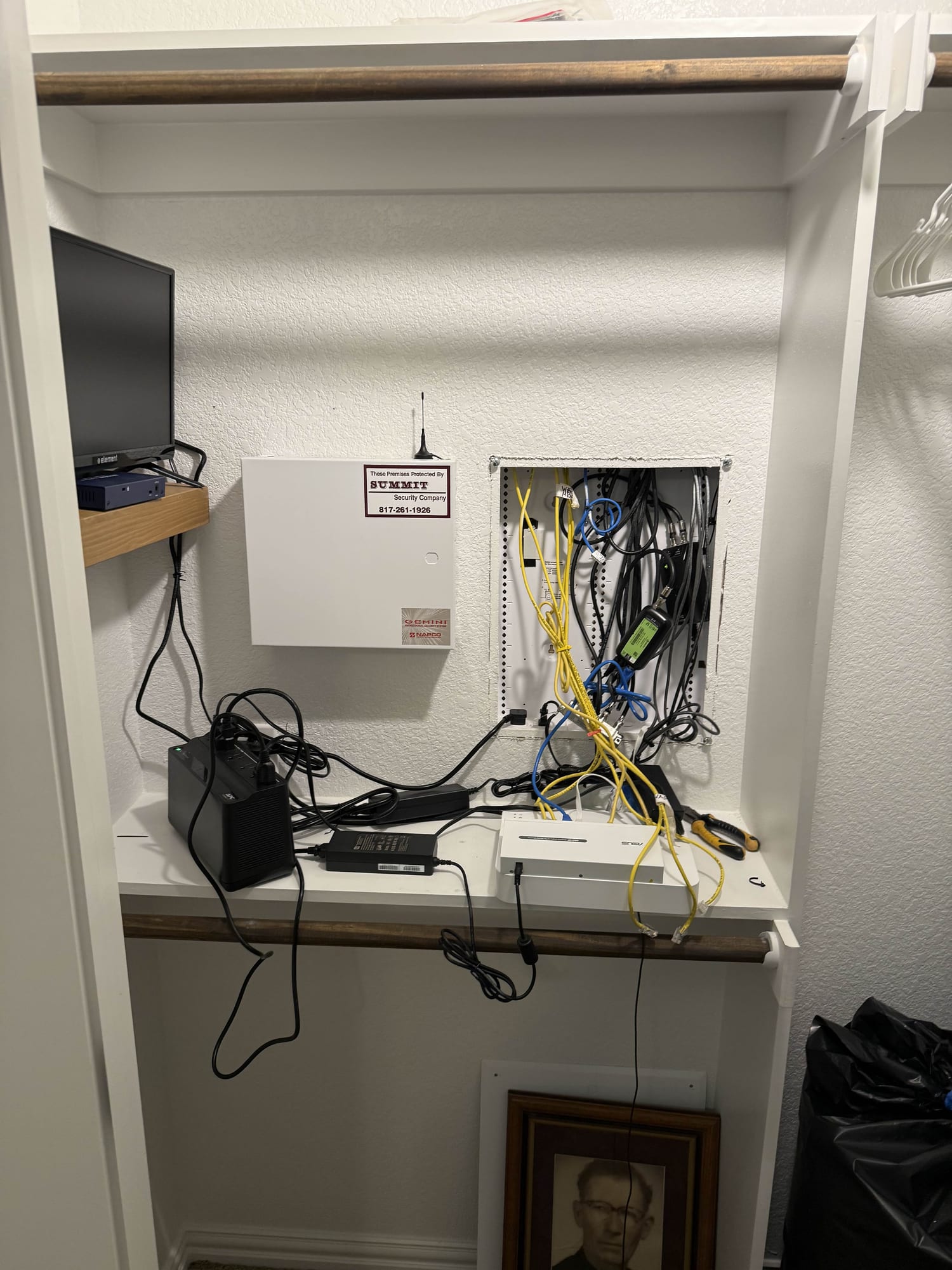 Network closet before cleanup — tangled unlabeled cabling
