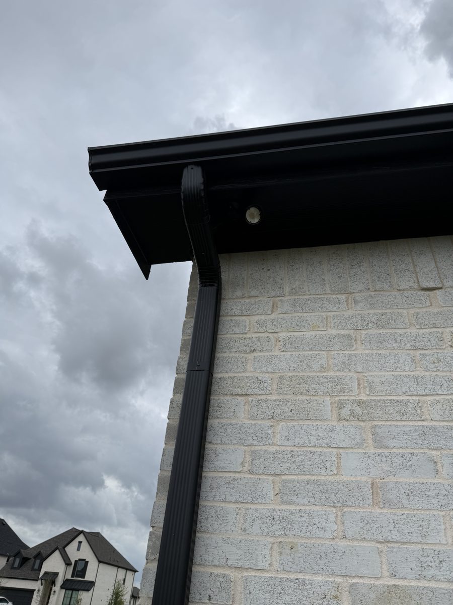 Camera recessed into soffit at roofline corner with fully concealed wiring
