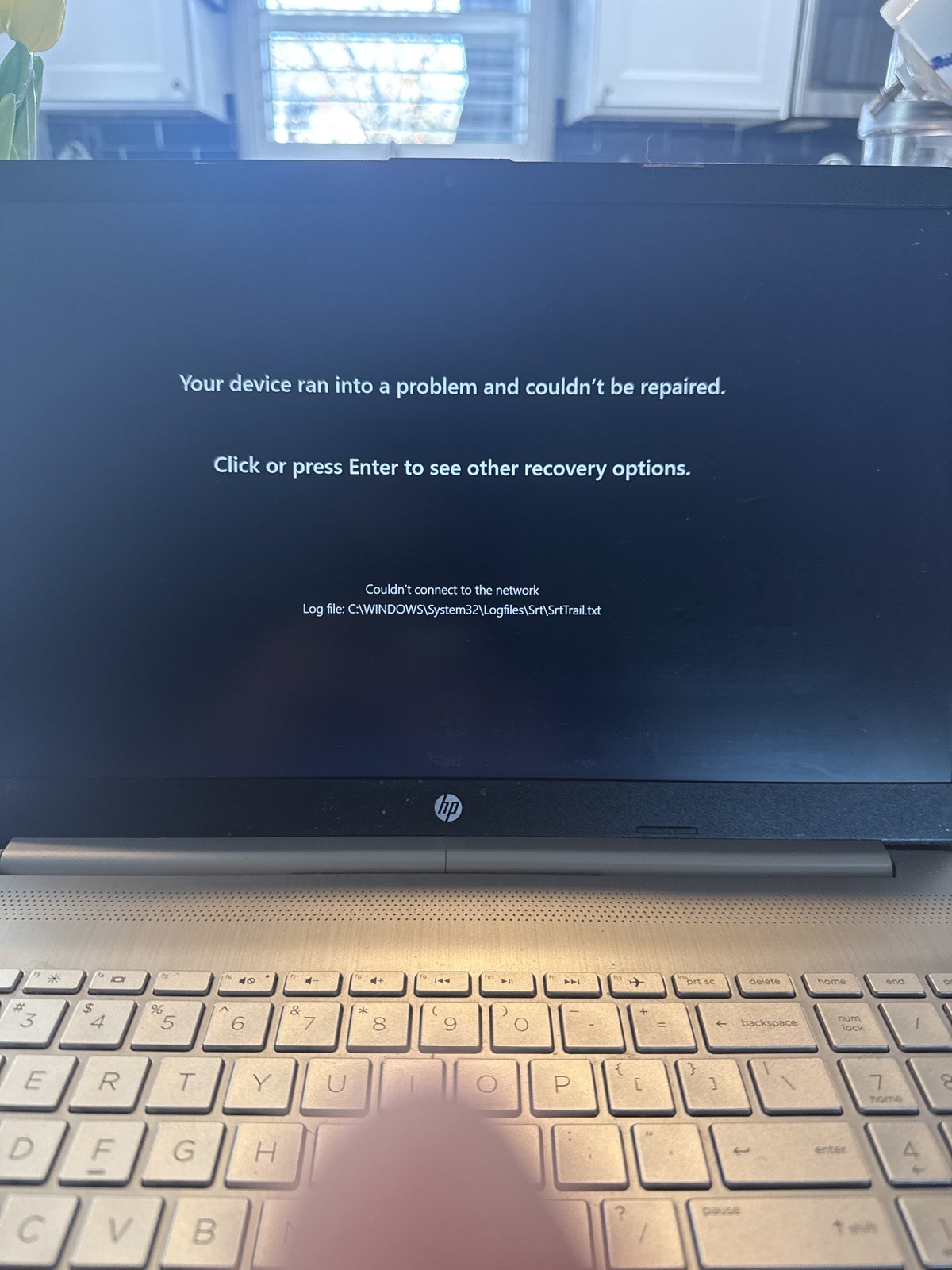 HP laptop showing a blue screen error during an on-site repair and Windows recovery