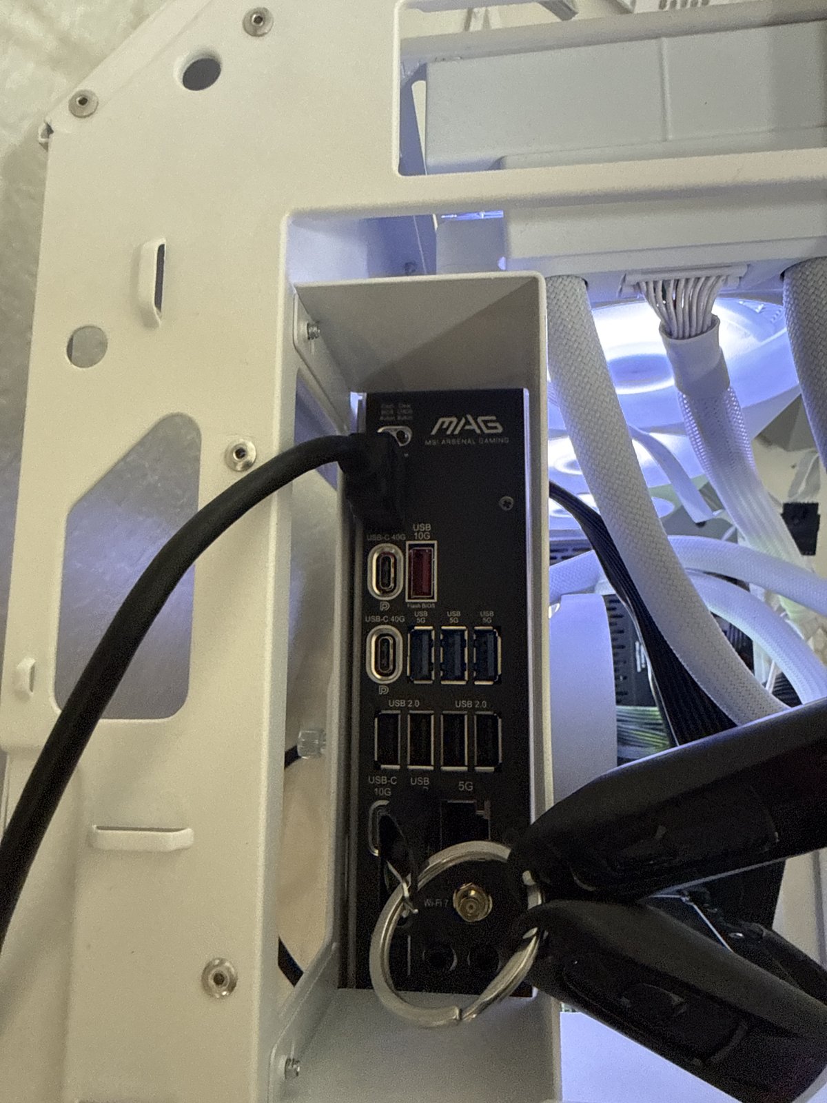 Rear I/O panel and cable management on an MSI MAG motherboard in a custom PC build
